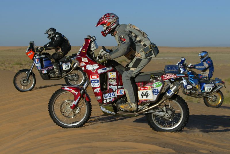D 0008 Dakar_2006_Floirac_Kastan_Cornuaille - Three motorcyclists on KTM machines.jpg